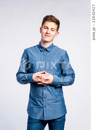 Boy in jeans and t-shirt, young man, studio shot Boy in jeans and t-shirt, young man, studio shot 22630427