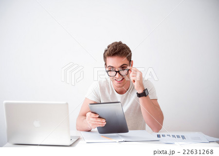 Pleasant  cheerful man sitting at the table  22631268