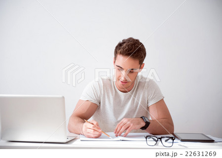 Pleasant  delighted man sitting at the table  22631269