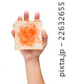 Hand holding a piece of bread with jam isolated 22632655