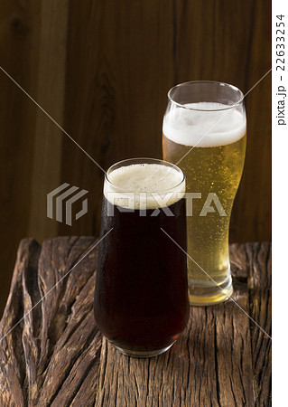 Craft Beer sitting on a rustic wooden bar. 22633254