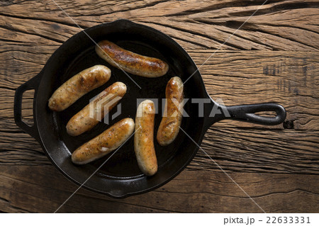 Butchers sausages in a frying pan. 22633331
