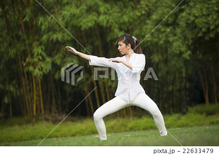 Chinese woman doing Tai Chi outdoors. Chinese woman doing Tai Chi outdoors. 22633479