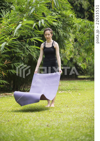 Chinese woman practicing yoga outdoors. 22633531