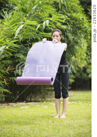 Chinese woman practicing yoga outdoors. Chinese woman practicing yoga outdoors. 22633620