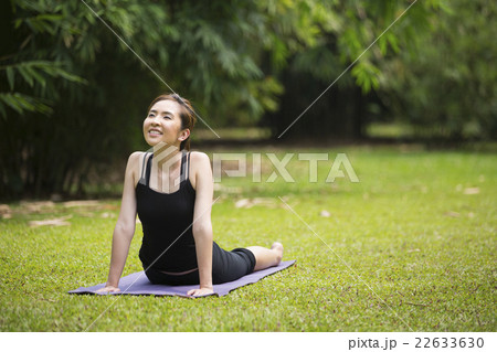 Chinese woman practicing yoga outdoors. Chinese woman practicing yoga outdoors. 22633630