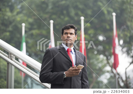 Indian business Man using his Smart phone outdoors. 22634003