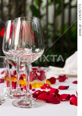 Wine glass table set with rose petals decorations Wine glass table set with rose petals decorations 22636773
