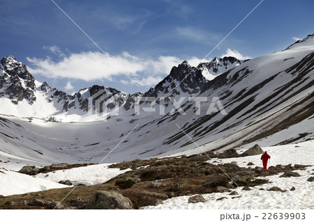 Hiker at snowy mountains in evening Hiker at snowy mountains in evening 22639903