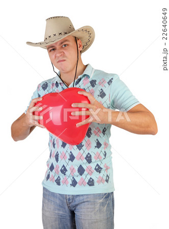 The young guy holding a red heart-shaped balloon on a white back 22640649
