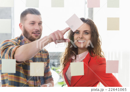 Businessman and businesswoman working in office 22641065