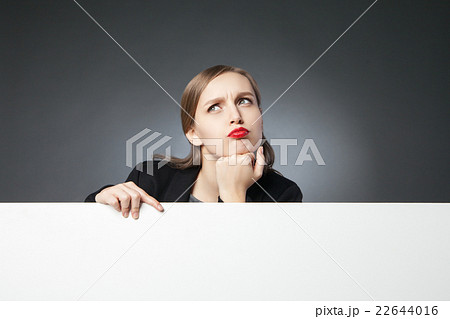 Puzzled businesswoman looking up 22644016