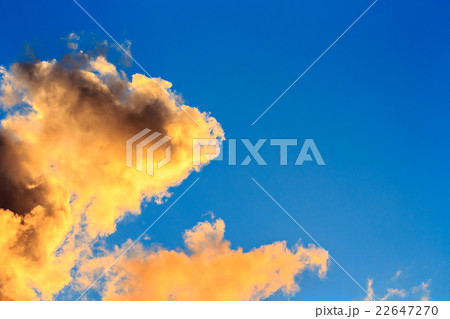 Orange clouds on blue sky background Orange clouds on blue sky background 22647270