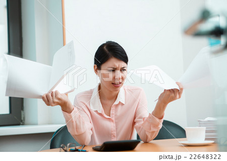 Woman in office with crumpled paper. 22648322
