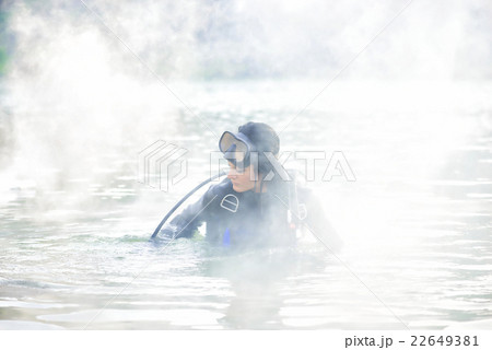 Woman diver in water shrouded in smoke 22649381