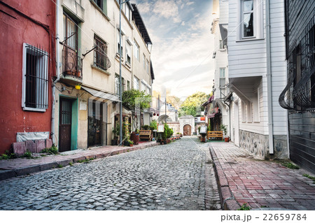 Narrow street lined with stone 22659784
