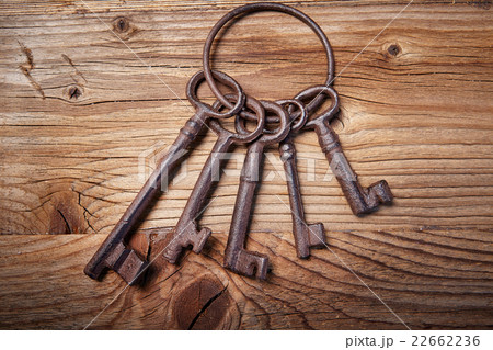 rusty medieval keys on wood table 22662236