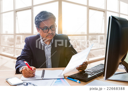 senior working man reading business paper report 22668388