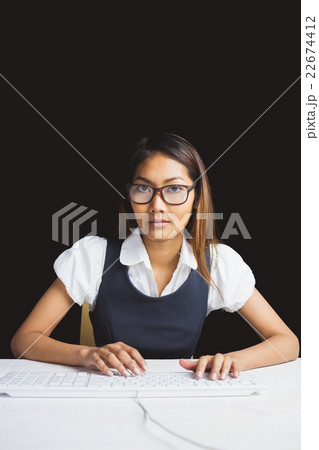 Serious businesswoman using a computer Serious businesswoman using a computer 22674412