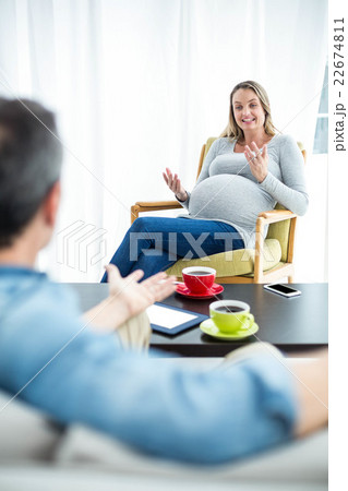 Pregnant woman interacting with man 22674811
