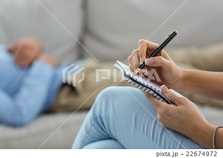 Female doctor writing on notepad while consulting a man Female doctor writing on notepad while consulting a man 22674972
