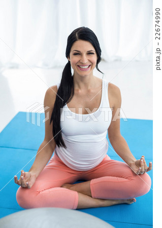 Pregnant woman meditating on mat Pregnant woman meditating on mat 22674990