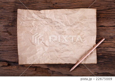Old paper with pencil on wooden table 22675009