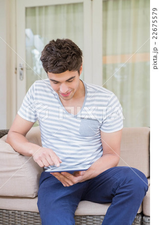 Young man using digital tablet Young man using digital tablet 22675579