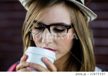 Woman drinking a beverage 22675597