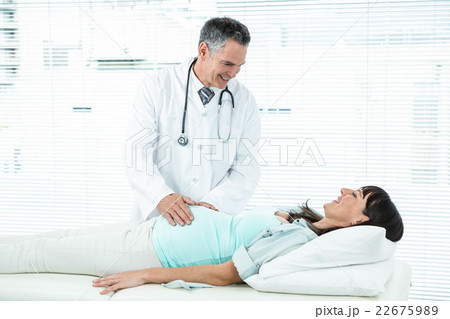 Doctor examining a pregnant woman 22675989