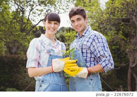 Young couple holding a sapling 22676072