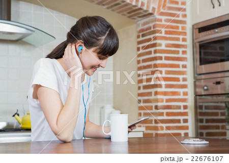 Young woman listening to music on smartphone 22676107