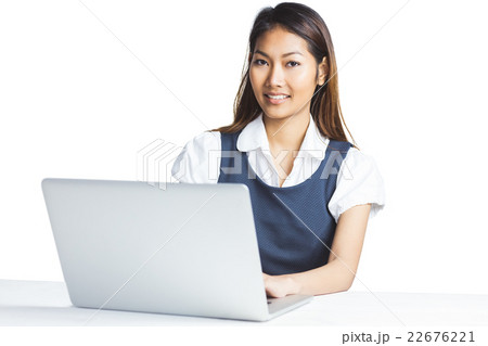 Smiling businesswoman using a laptop Smiling businesswoman using a laptop 22676221