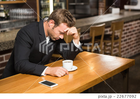 Handsome man looking at smartphone and having a coffee 22677092