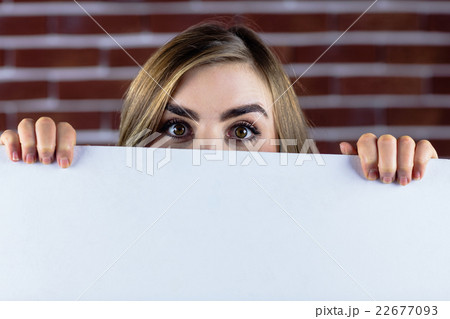 Pretty blonde woman holding a white sign Pretty blonde woman holding a white sign 22677093