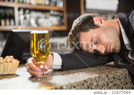 Tired man having a beer Tired man having a beer 22677094