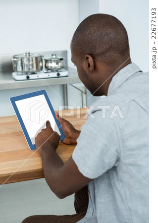 Man using digital tablet in kitchen 22677193