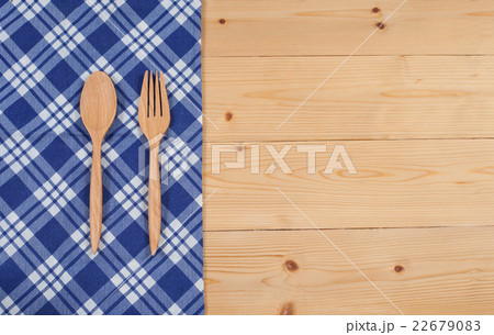 Tablecloth, wooden spoon, fork on wood textured 22679083