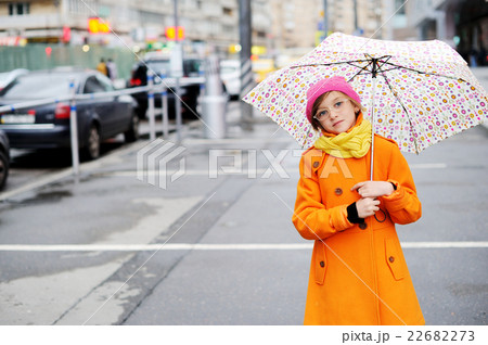 Colorful kid girl with umbrella on city street Colorful kid girl with umbrella on city street 22682273