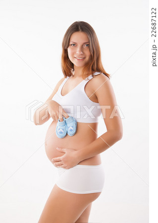 Pregnant woman holding pair of shoes for baby Pregnant woman holding pair of shoes for baby 22687122