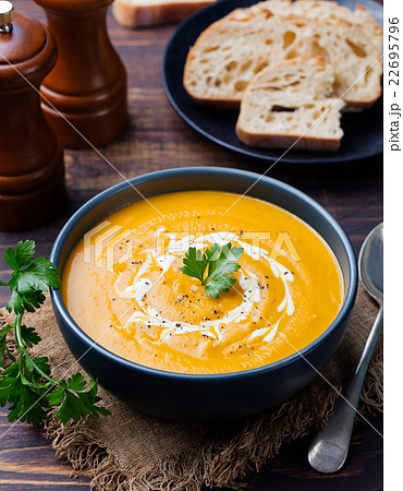 Pumpkin and carrot soup with cream and parsley Pumpkin and carrot soup with cream and parsley 22695796