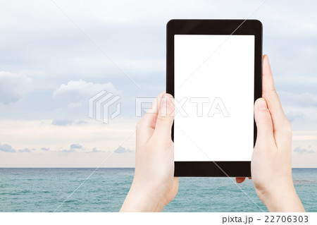 tourist photographs calm Black Sea in autumn 22706303