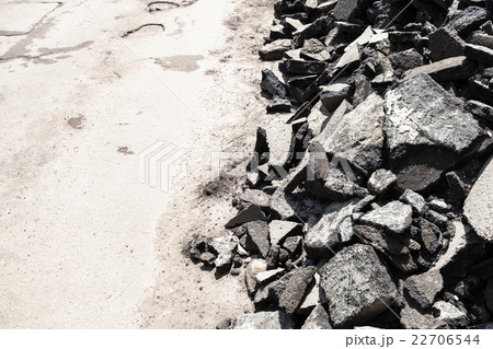 heap of old asphalt pieces on roadside 22706544