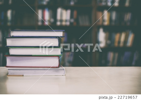 Stack of books on desk with vintage filter Stack of books on desk with vintage filter 22719657