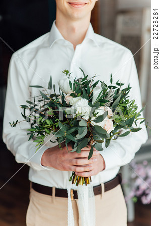 Beautiful wedding bouquet in hands of the groom 22723284