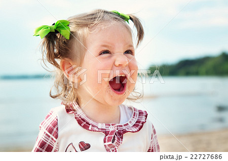 Funny little girl shouting at the sea Funny little girl shouting at the sea 22727686