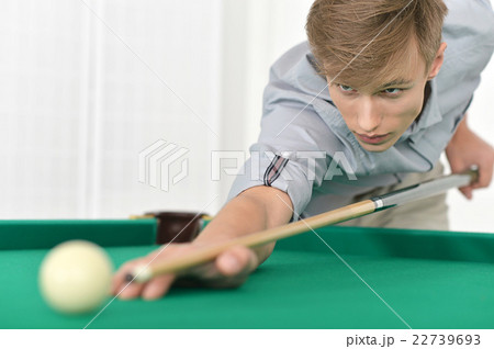 man playing billiards in  billiard club 22739693