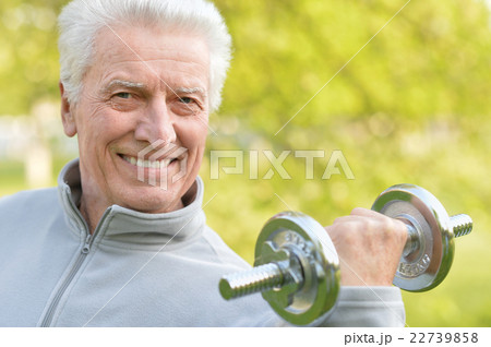 Elderly man exercising with dumbbell 22739858