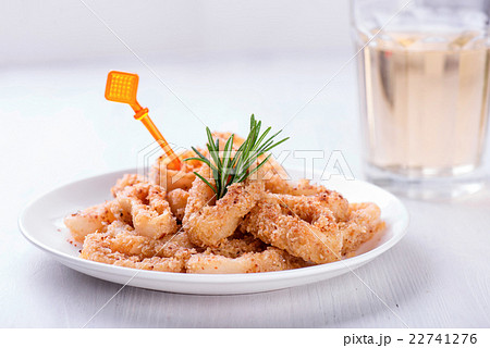Fried squid rings with lemon, herbs and spices 22741276