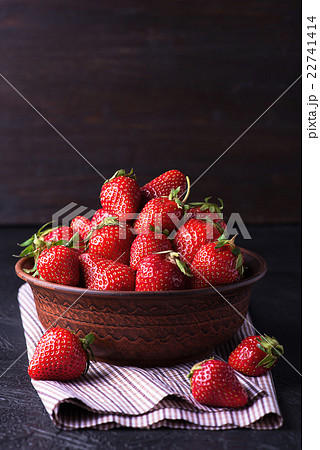 Fresh strawberry in the brown bowl on dark table 22741414